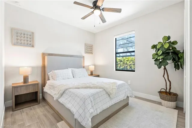 a bedroom with a bed and a potted plant