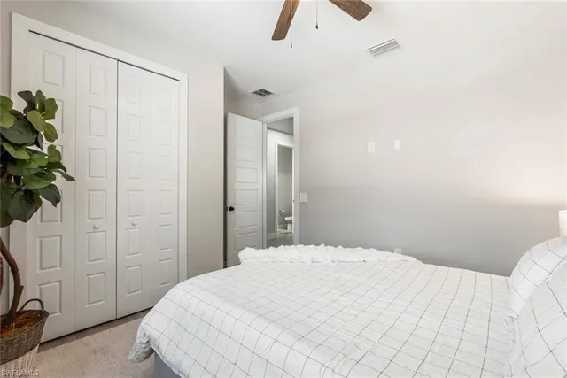 a bedroom with a bed and a plant