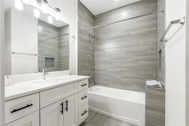 a bathroom with a sink mirror toilet and bathtub