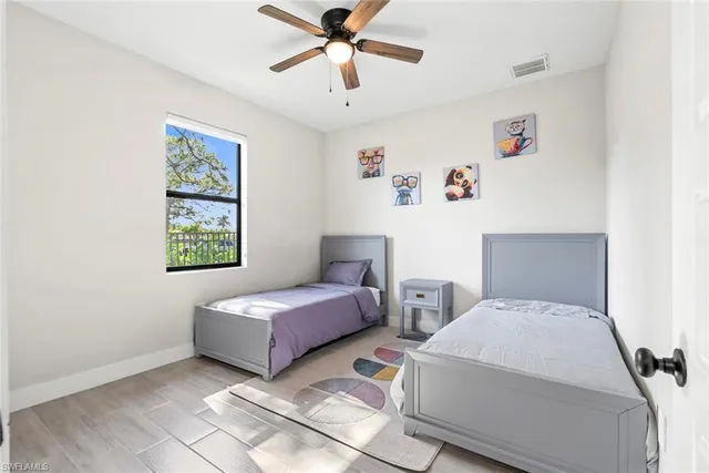 a bedroom with two beds and a chandelier