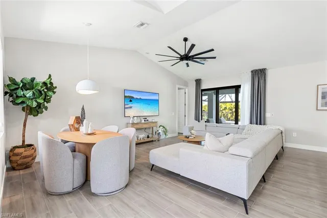 a living room with furniture a chandelier and a window