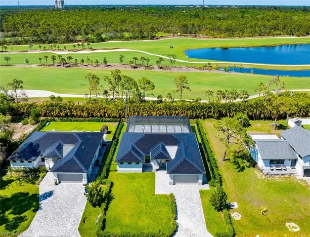 an aerial view of a house with a big yard