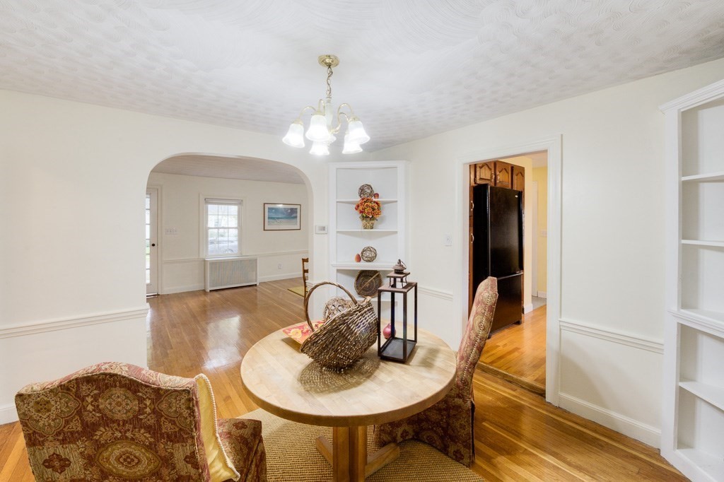 13 Westbrook Road Worcester, MA 01602 - Photo 16 of 41 a dining room with wooden floor a chandelier a wooden table and chairs