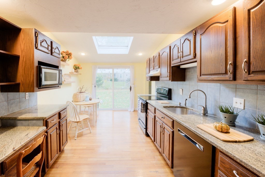 13 Westbrook Road Worcester, MA 01602 - Photo 19 of 41 a kitchen with stainless steel appliances granite countertop a sink stove and cabinets