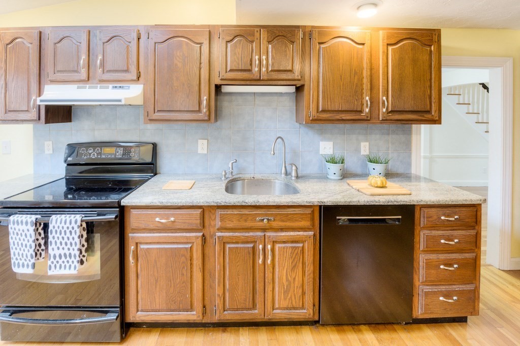 13 Westbrook Road Worcester, MA 01602 - Photo 21 of 41 a kitchen with stainless steel appliances granite countertop a sink dishwasher stove and cabinets