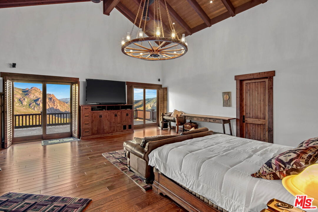 12486 Yerba Buena Road Malibu, CA 90265 - Photo 19 of 68 a bedroom with bed and wooden floor
