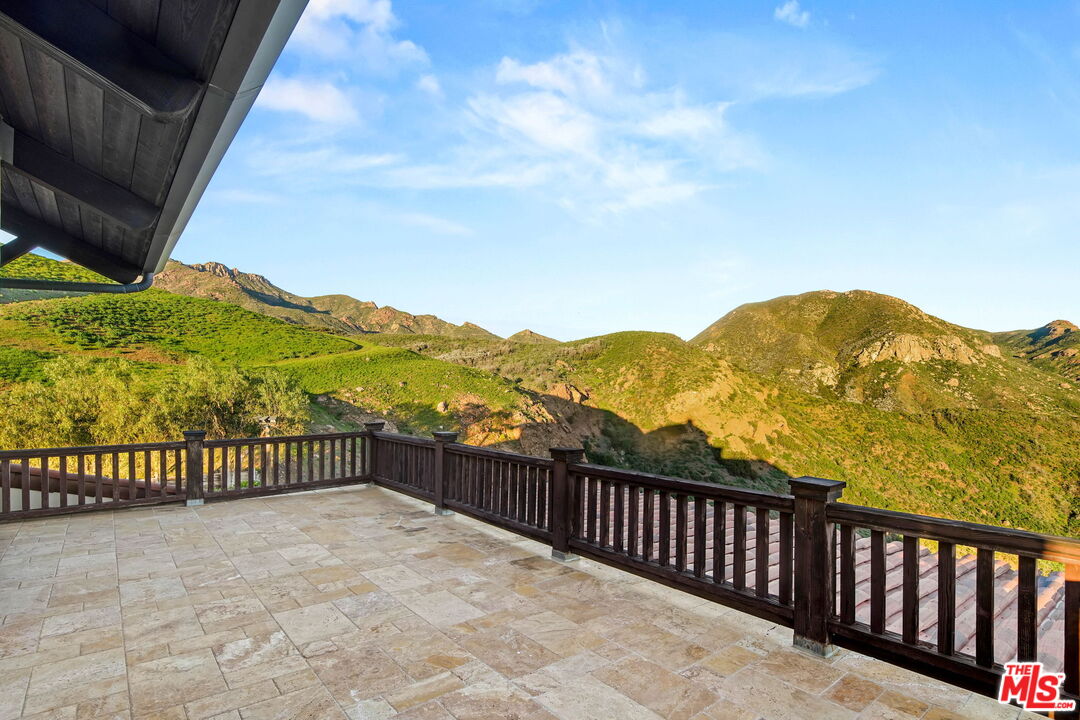 12486 Yerba Buena Road Malibu, CA 90265 - Photo 21 of 68 a view of a balcony with wooden fence and floor