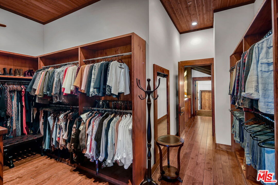 12486 Yerba Buena Road Malibu, CA 90265 - Photo 25 of 68 a view of walk in closet with clothes and shoes