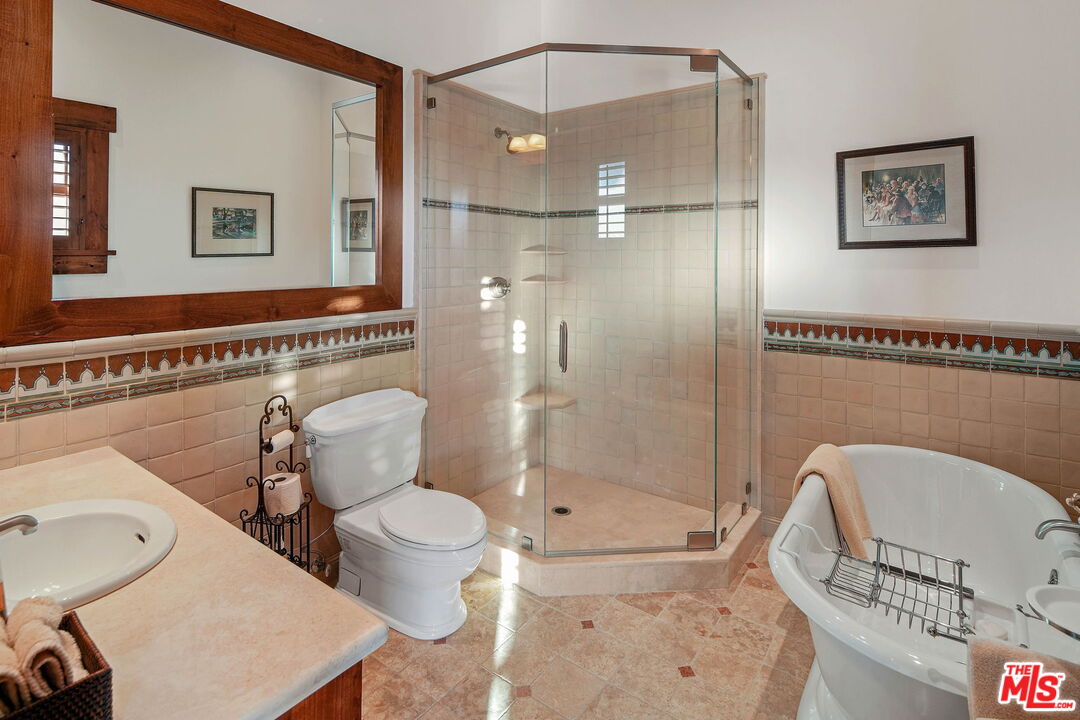 12486 Yerba Buena Road Malibu, CA 90265 - Photo 29 of 68 a bathroom with a toilet a sink and a shower