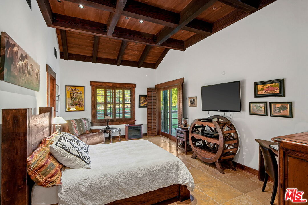 12486 Yerba Buena Road Malibu, CA 90265 - Photo 30 of 68 a bedroom with a bed a couch and dresser
