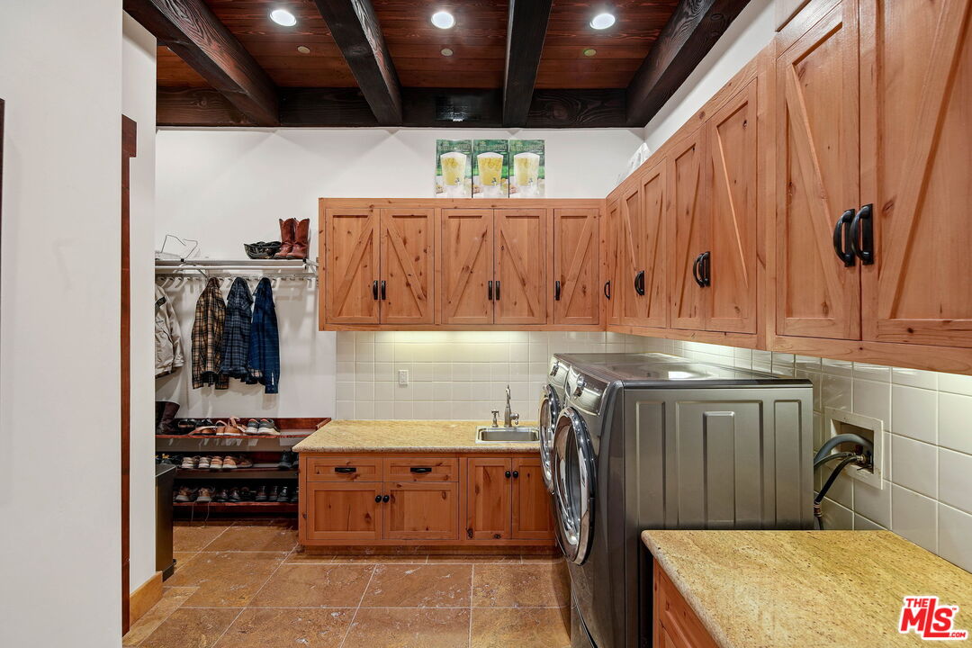 12486 Yerba Buena Road Malibu, CA 90265 - Photo 32 of 68 a kitchen with a refrigerator and a stove