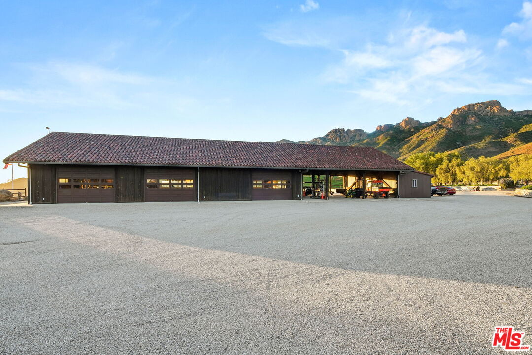 12486 Yerba Buena Road Malibu, CA 90265 - Photo 35 of 68 a front view of a house with a yard and garage