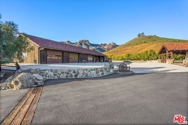 a view of a house with a yard and balcony