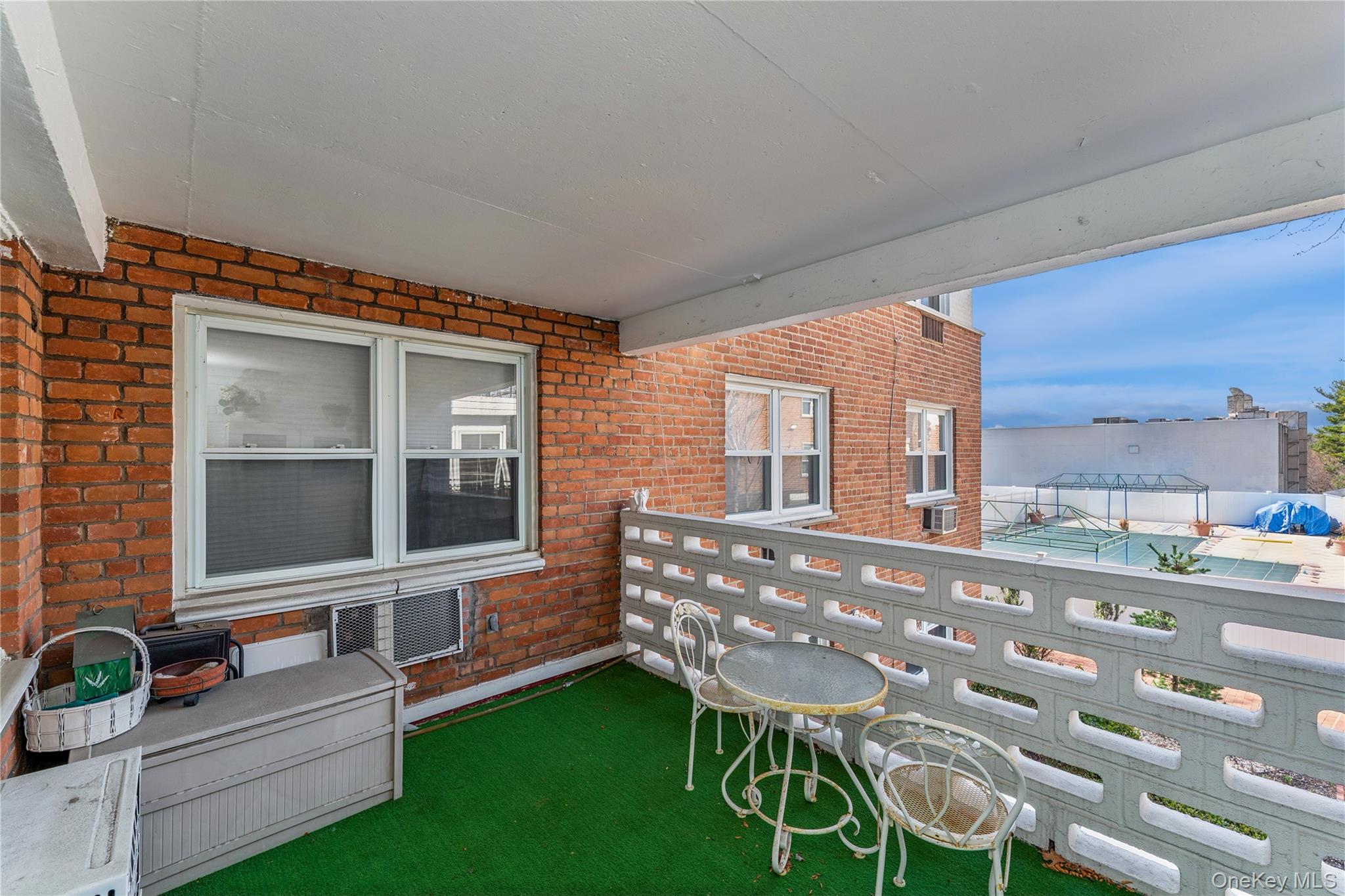 200 South Middle Neck Road, Unit F6 Great Neck, NY 11021 - Photo 14 of 16 a view of a chairs and table in the back yard of the house