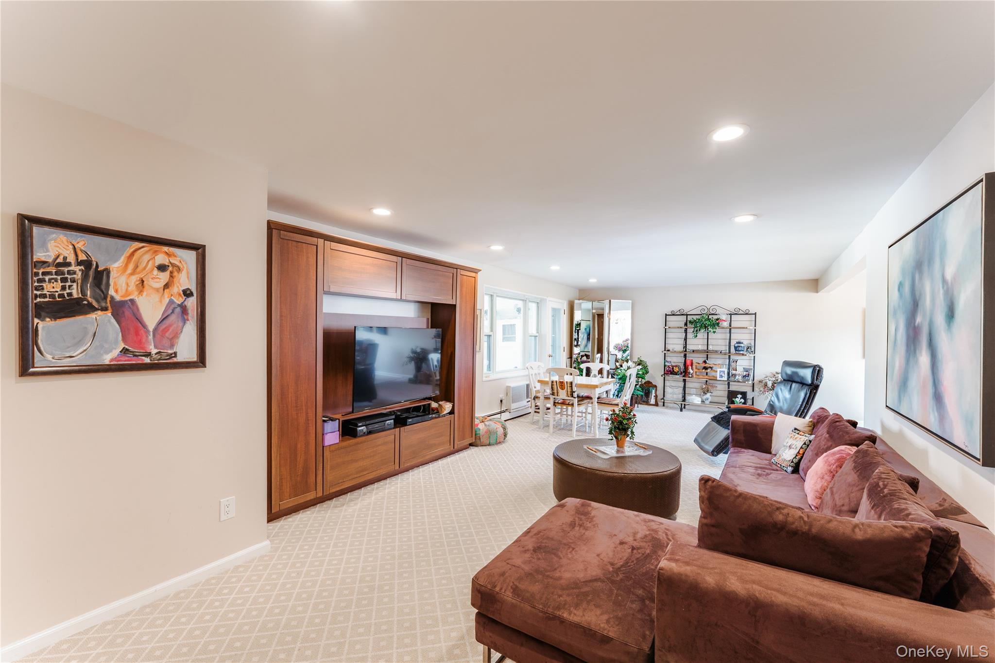 200 South Middle Neck Road, Unit F6 Great Neck, NY 11021 - Photo 2 of 16 a living room with furniture and a flat screen tv