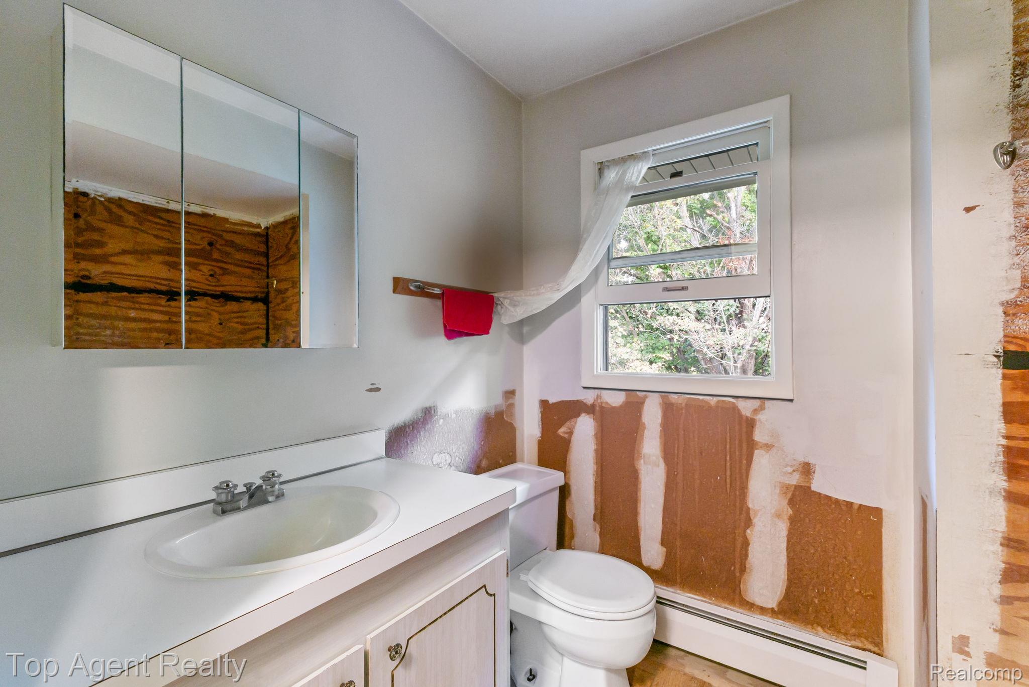 8269 Currie Road Northville, MI 48168 - Photo 29 of 80 White vanity with an integrated sink and chrome faucet