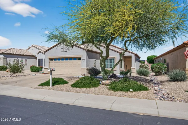 a front view of a house with a yard and garage