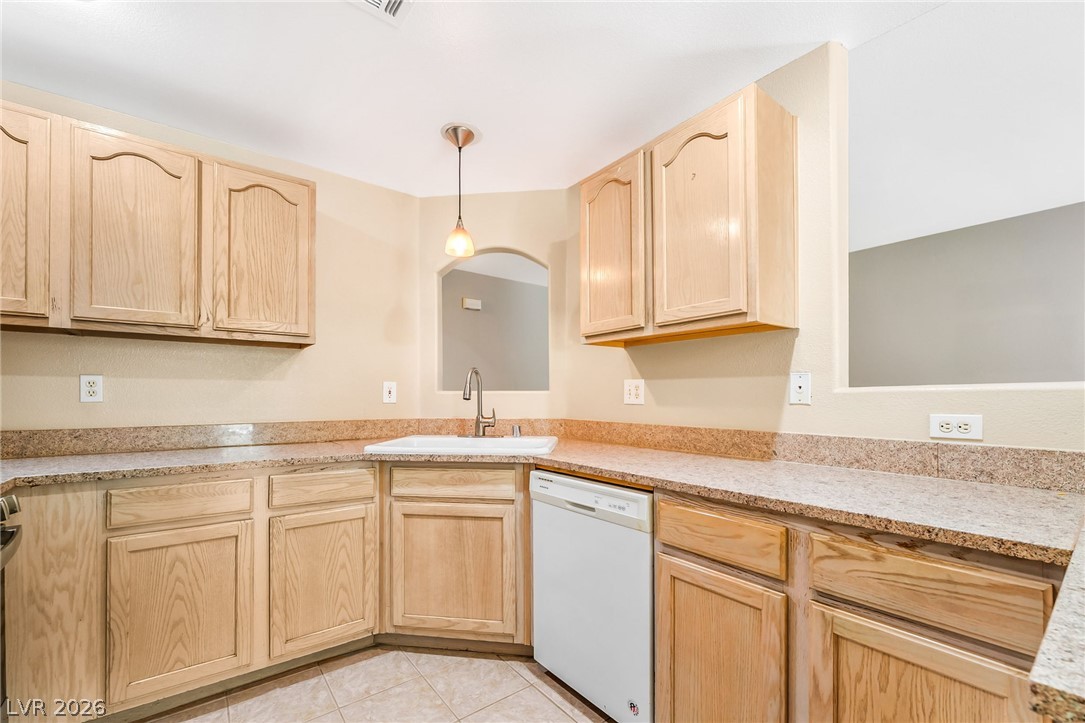 2050 West Warm Springs Road, Unit 2411 Henderson, NV 89014 - Photo 12 of 37 Functional kitchen with ample cabinetry and speckled countertops awaits your culinary touch.