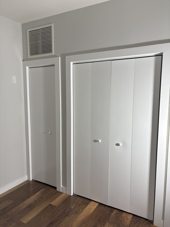 45 1st Avenue, Unit 111 Boston, MA 02129 - Photo 5 of 8 a view of an empty room with wooden floor and a window