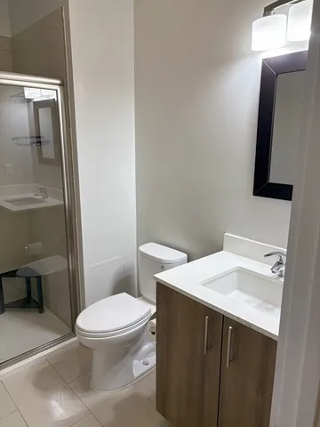 a white toilet sitting next to a bathroom sink