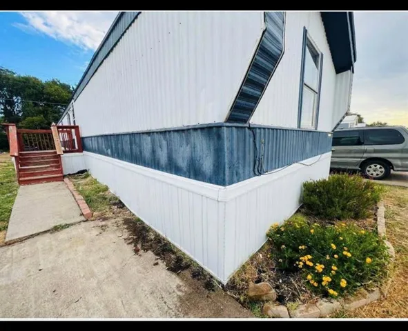 a view of a backyard with sitting area