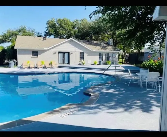 a view of a swimming pool with a patio