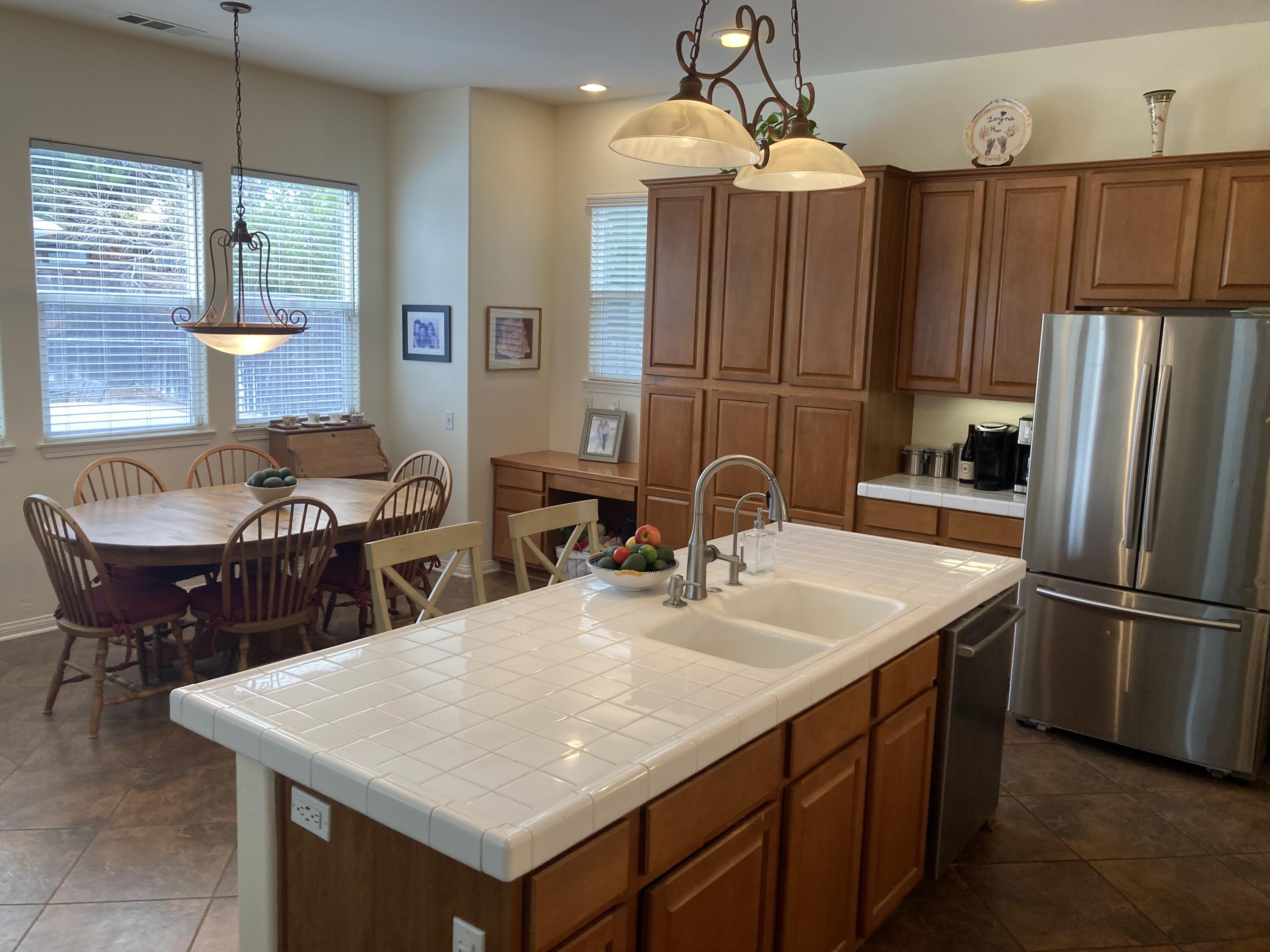 363 Quail Run Road Buellton, CA 93427 - Photo 12 of 25 a kitchen with stainless steel appliances granite countertop a sink a microwave a dining table and chairs