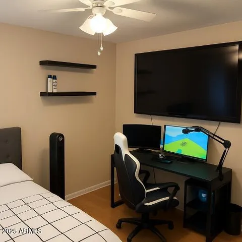 a view of a workspace with furniture and a flat screen tv