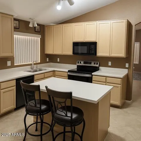 a view of a white house with a large space in front of it