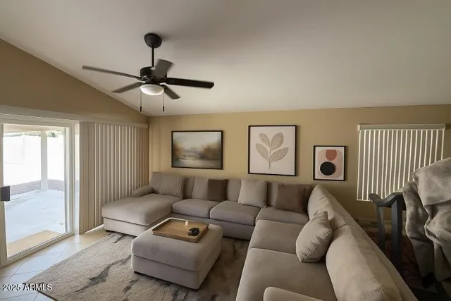 a living room with furniture and a ceiling fan