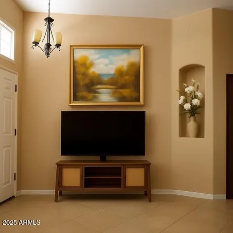 a living room with a bed and a flat screen tv