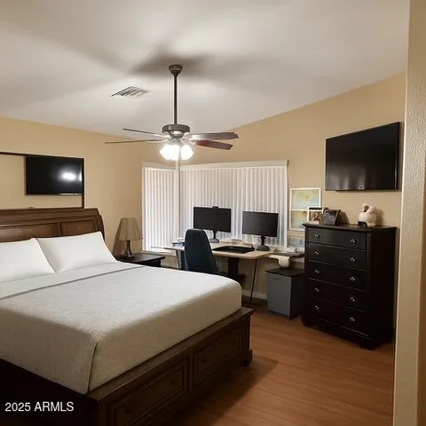 a bedroom with a bed and a flat screen tv