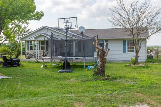 a living room with furniture a rug and a chandelier