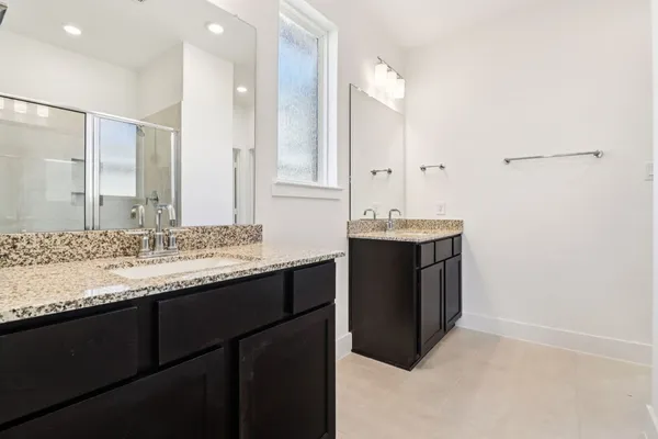 a bathroom with a sink vanity and a mirror