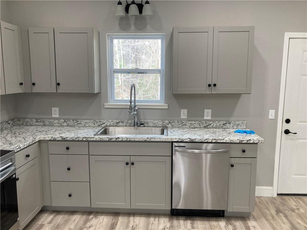 100 A Dickerson Road Dahlonega, GA 30533 - Photo 5 of 15 a kitchen with granite countertop white cabinets and a sink