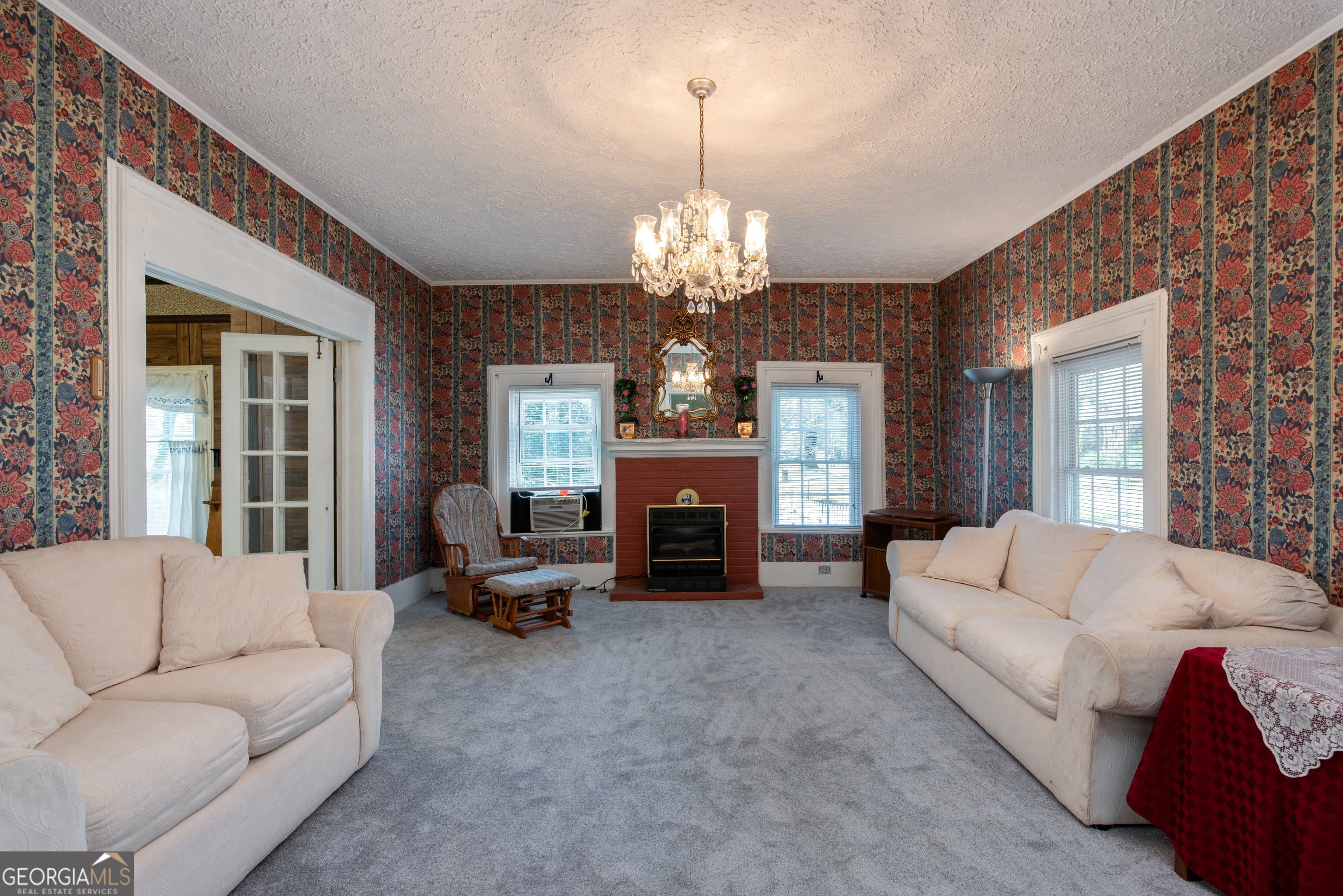 170 Fairplay Street Rutledge, GA 30663 - Photo 4 of 45 Gorgeous chandelier, wide molding, original details and tall windows that bring in tons of natural light. Check out the accordion French doors!