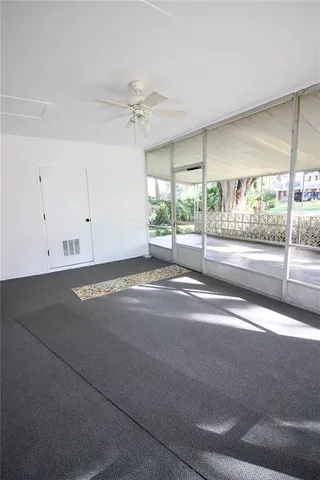 a view of a livingroom with a fan and window