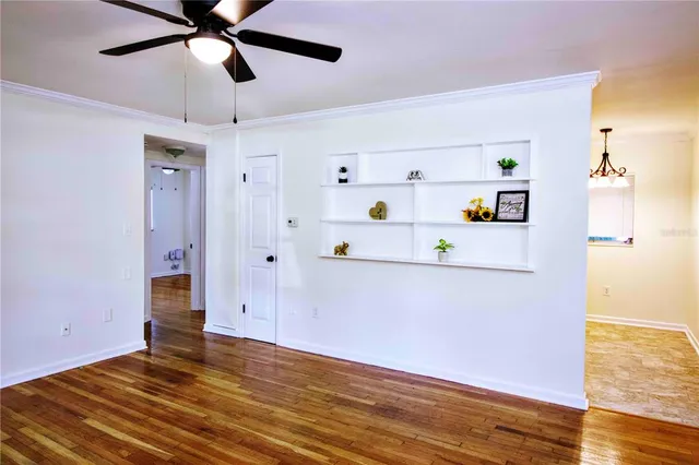 a view of empty room with wooden floor