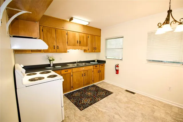 a kitchen with a stove a sink and a refrigerator