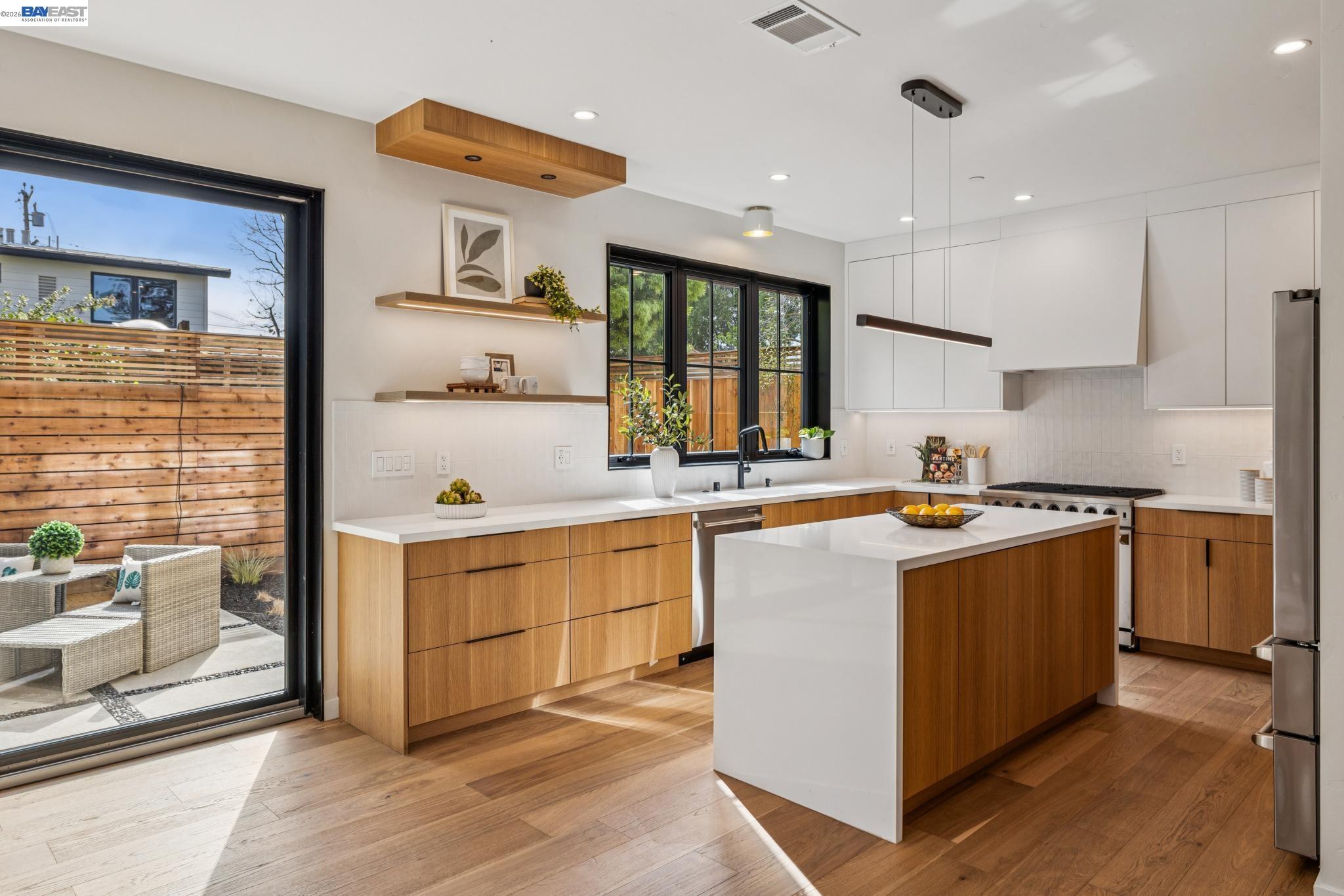 1142 Dwight Way Berkeley, CA 94702 - Photo 18 of 60 a kitchen that has a lot of cabinets in it and wooden floors