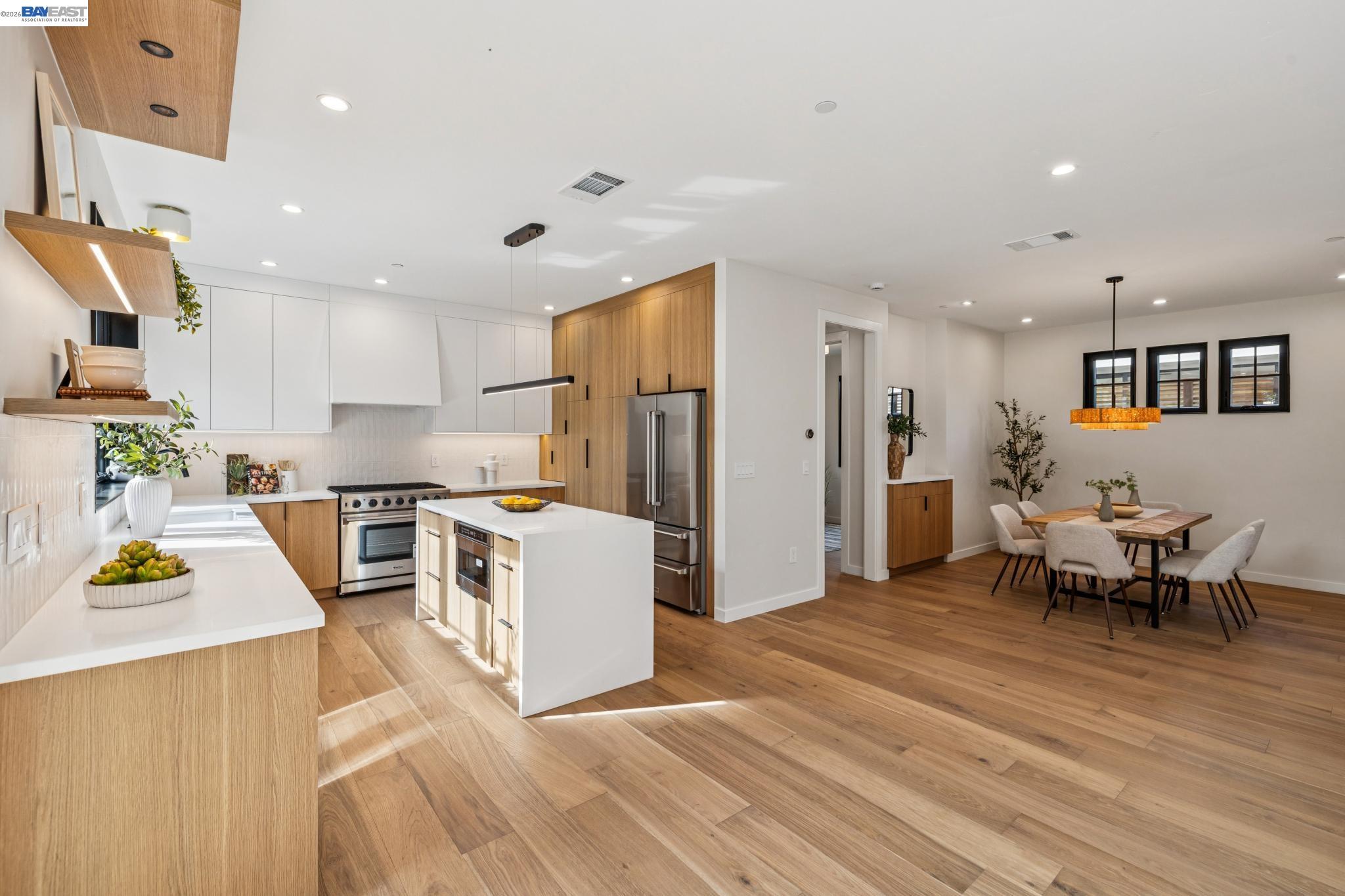 1142 Dwight Way Berkeley, CA 94702 - Photo 20 of 60 a kitchen with stainless steel appliances refrigerator wooden floor dining table and chairs
