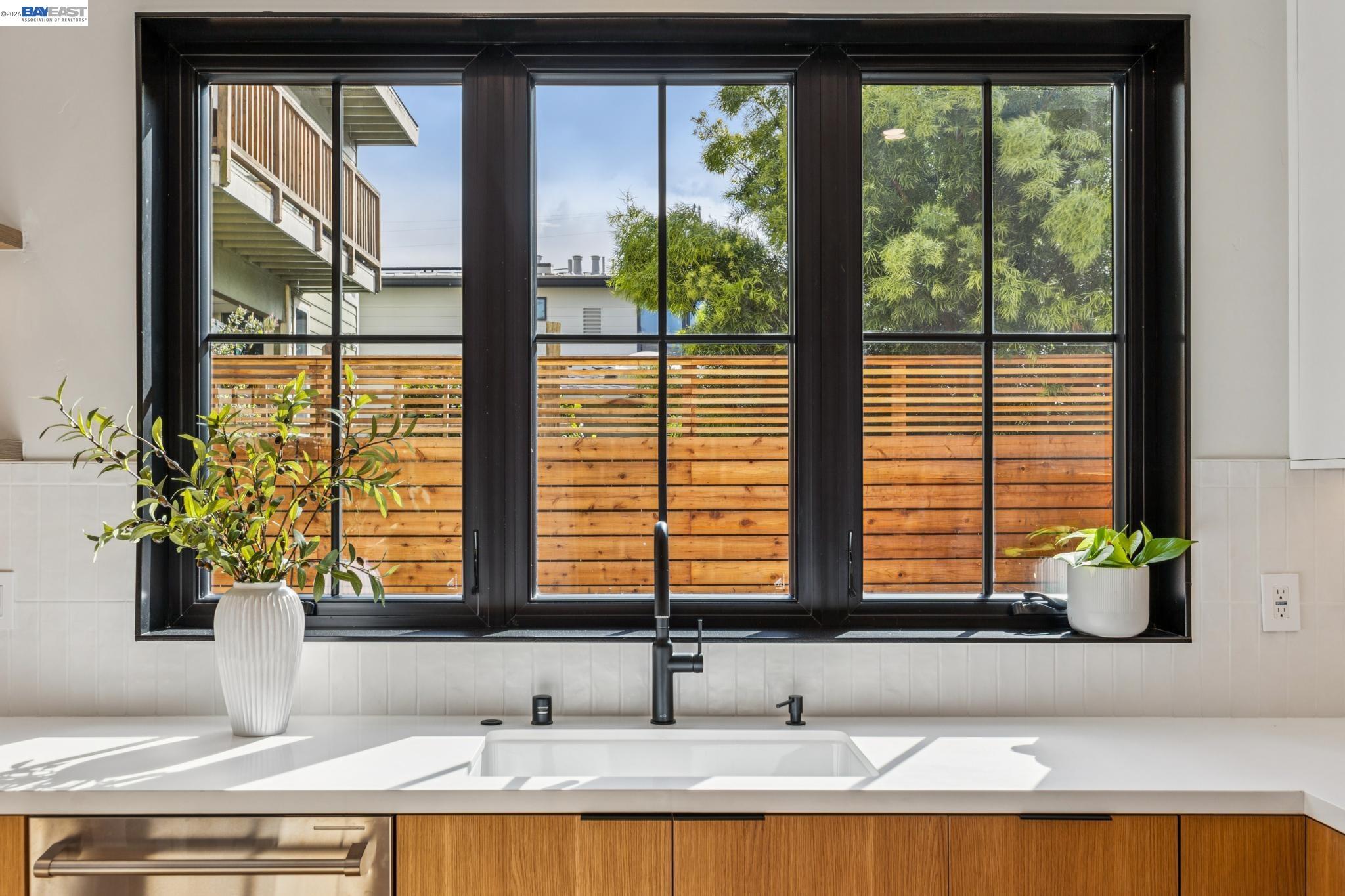 1142 Dwight Way Berkeley, CA 94702 - Photo 24 of 60 a bathroom with a granite countertop sink and a large window