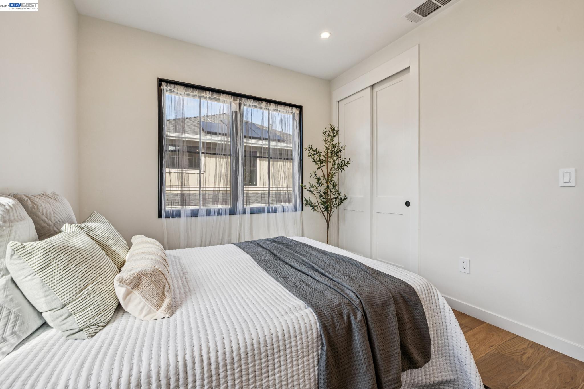 1142 Dwight Way Berkeley, CA 94702 - Photo 43 of 60 a bedroom with a large bed and a large window