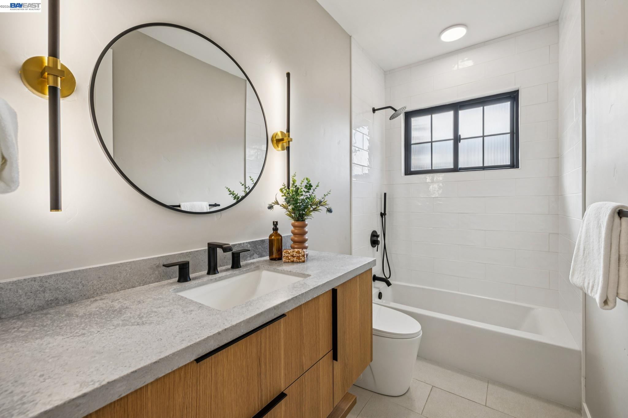 1142 Dwight Way Berkeley, CA 94702 - Photo 48 of 60 a bathroom with a granite countertop sink a toilet and a mirror