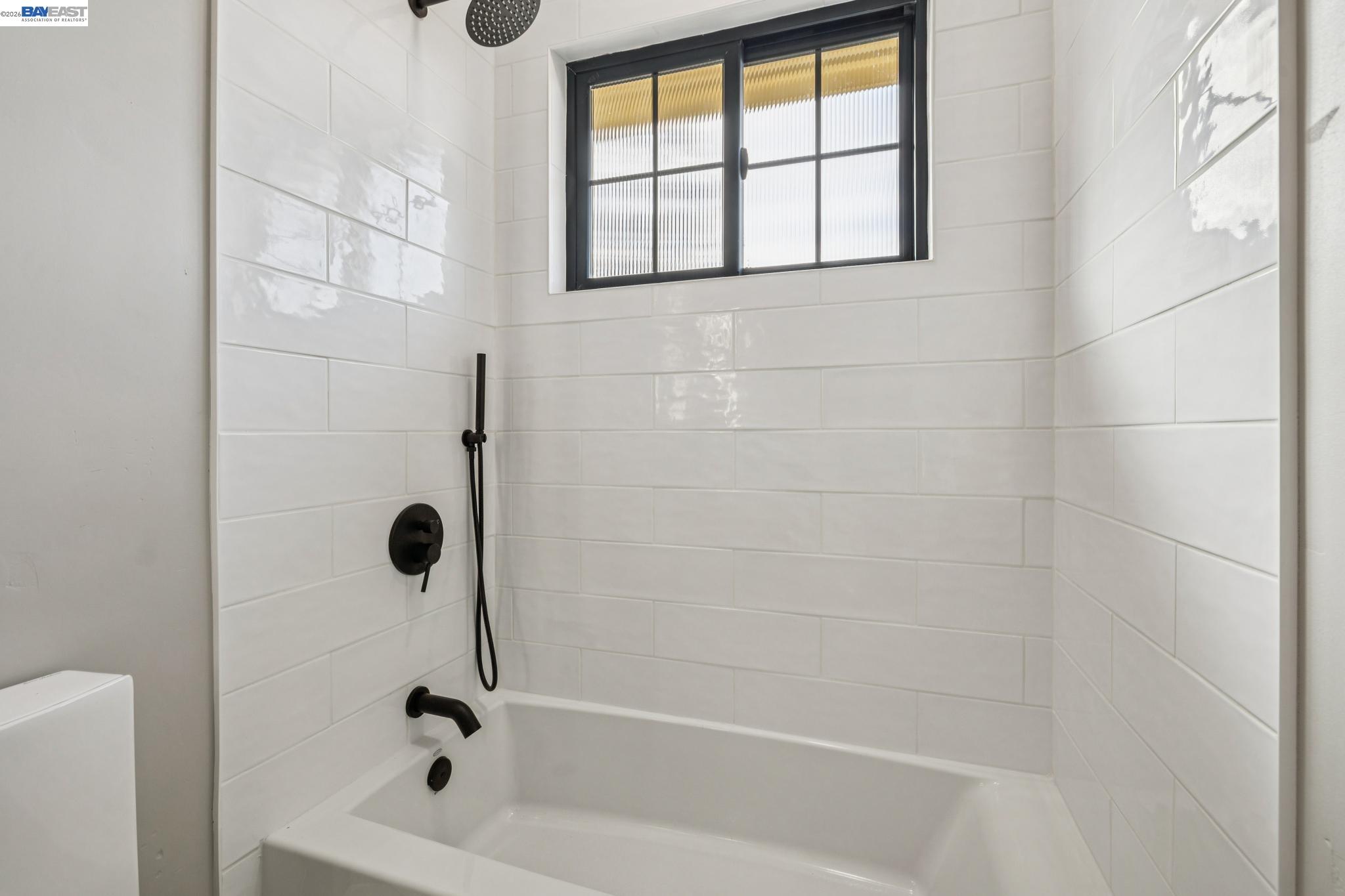 1142 Dwight Way Berkeley, CA 94702 - Photo 50 of 60 a bathroom with a bathtub and a shower