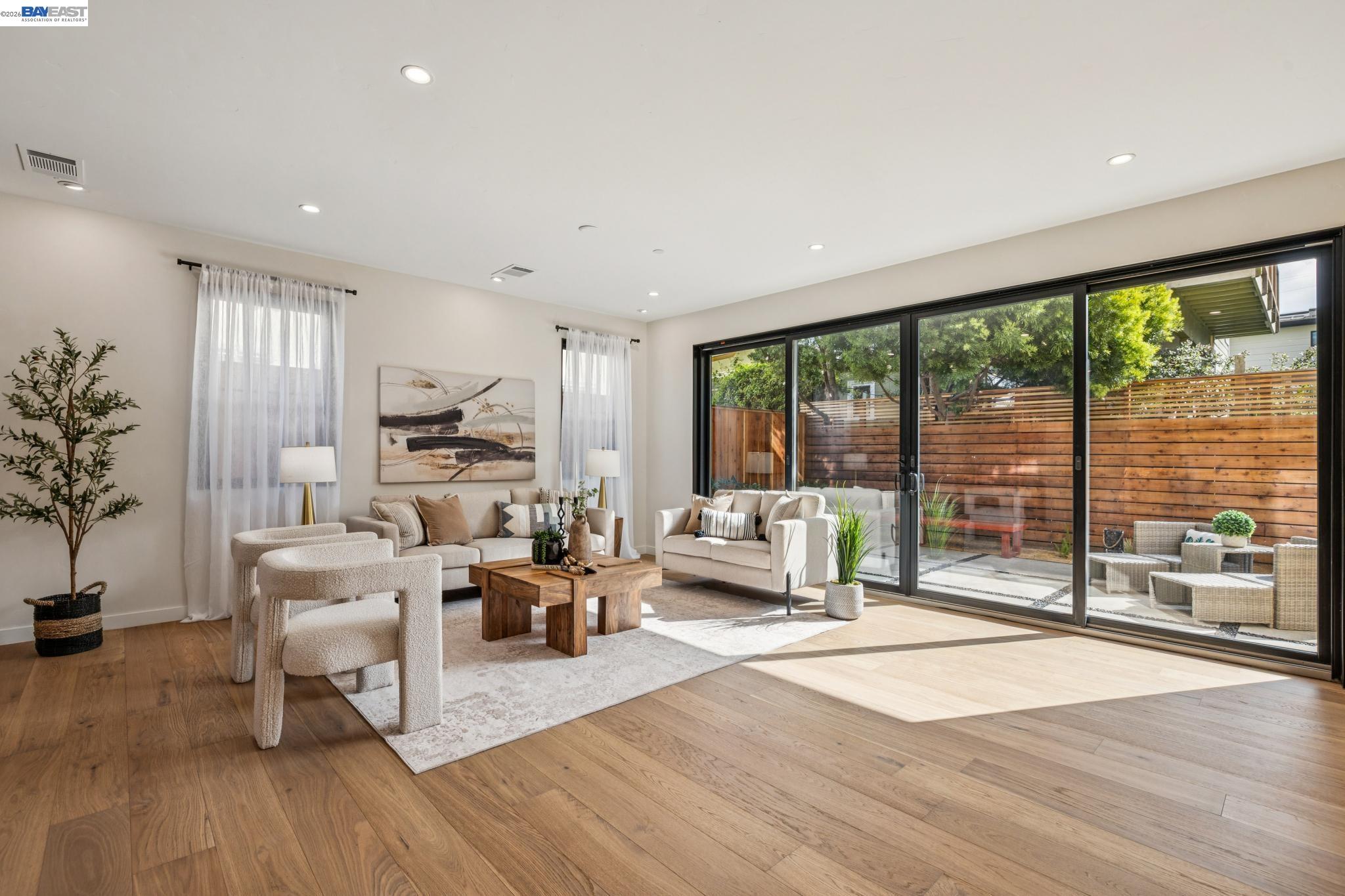 1142 Dwight Way Berkeley, CA 94702 - Photo 8 of 60 a living room with furniture large windows and wooden floor