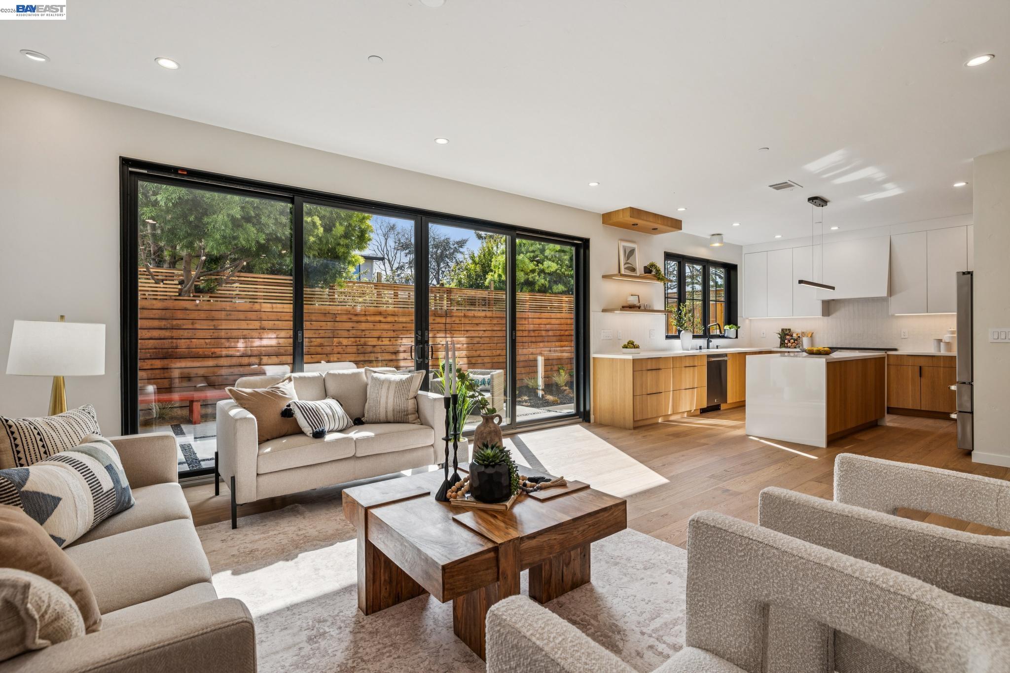 1142 Dwight Way Berkeley, CA 94702 - Photo 10 of 60 a living room with furniture floor to ceiling window and a kitchen view