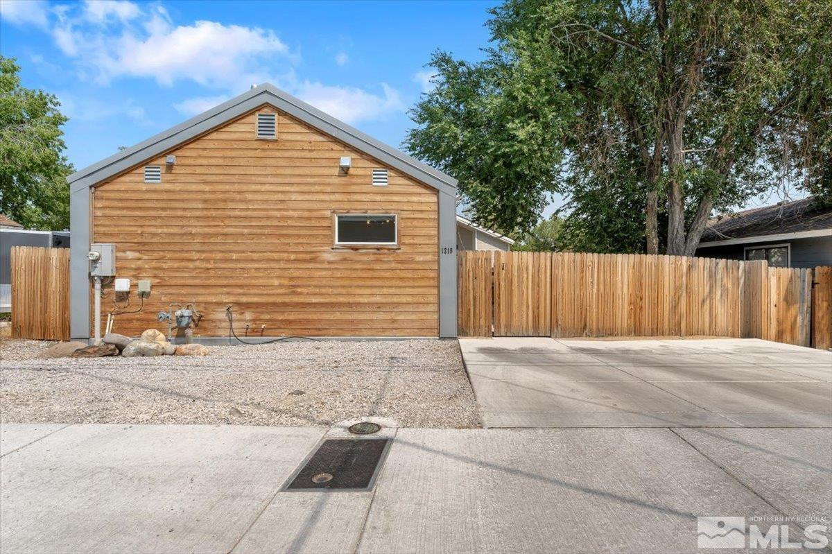 1219 Lander Street Reno, NV 89509 - Photo 1 of 18 a front view of a house with a garage
