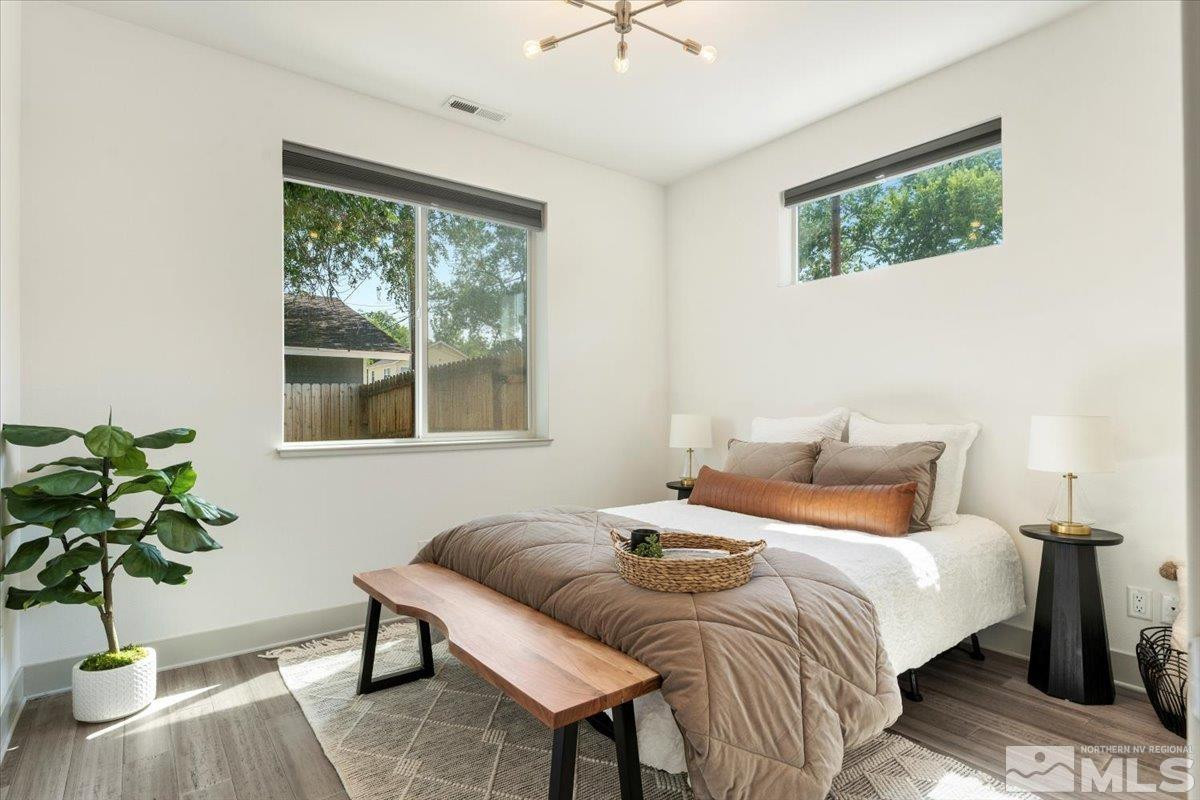 1219 Lander Street Reno, NV 89509 - Photo 12 of 18 a bedroom with a bed a dresser and a potted plant