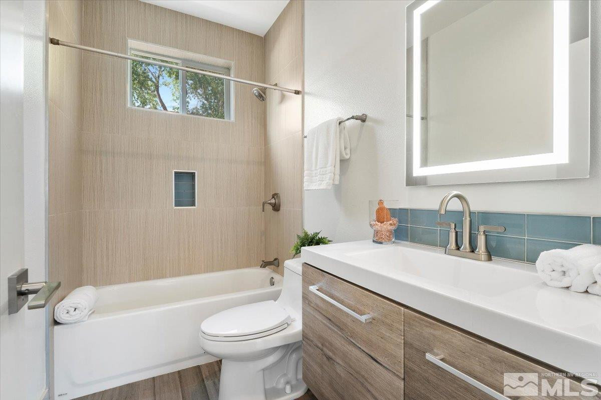 1219 Lander Street Reno, NV 89509 - Photo 14 of 18 a bathroom with a sink a toilet and shower